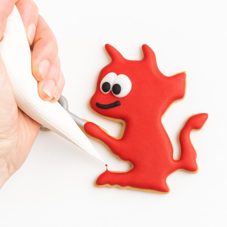 ciasteczko diabełek z widłami lifestylowe zdjęcie cukiernik dekorujący ciasteczko