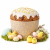 Upieczone panettone w papierowej formie z białą polewą, otoczone pisankami i wielkanocnymi dekoracjami