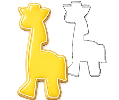 Metalowa foremka do ciastek żyrafa obok lukrowanego na żółty kolor ciastka