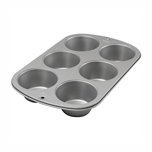 Metalowa forma Wilton na muffiny z sześcioma okrągłymi wgłębieniami do pieczenia.