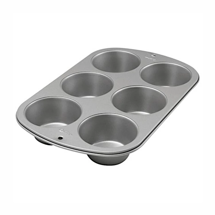 Metalowa forma Wilton na muffiny z sześcioma okrągłymi wgłębieniami do pieczenia.